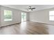 Living room showing hardwood floors, two windows, and sliding glass door at 1313 Kenwood Dr, Greenwood, IN 46143