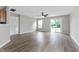 Bright living room with ceiling fan, hardwood floors, sliding glass door, and backyard view at 1313 Kenwood Dr, Greenwood, IN 46143