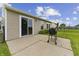 Concrete patio with grill, slider, lawn and privacy fencing at 1313 Kenwood Dr, Greenwood, IN 46143