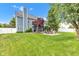 Spacious backyard with manicured lawn, paver patios, and mature shade trees at 13766 Heatherfield Dr, Fishers, IN 46038