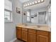 Bathroom with a double sink vanity, large mirror, and decorative coastal artwork at 13766 Heatherfield Dr, Fishers, IN 46038