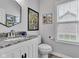 Stylish half bathroom with a granite countertop and elegant fixtures at 13766 Heatherfield Dr, Fishers, IN 46038