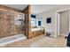 A luxurious bathroom features a glass shower, soaking tub, and a neutral color scheme at 13766 Heatherfield Dr, Fishers, IN 46038