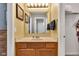 Bathroom showcasing a wood vanity, decorative mirror, and neutral color scheme at 13766 Heatherfield Dr, Fishers, IN 46038