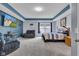 Spacious bedroom featuring a tray ceiling, carpeted floors, a television and a cozy seating area at 13766 Heatherfield Dr, Fishers, IN 46038