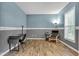 Comfortable bedroom with wood floors, a desk area, and plenty of natural light at 13766 Heatherfield Dr, Fishers, IN 46038