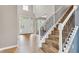 Bright foyer featuring hardwood floors, a staircase with iron railings and a transom window at 13766 Heatherfield Dr, Fishers, IN 46038