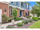 Inviting front porch with colorful flower beds and a sidewalk leading to the front door at 13766 Heatherfield Dr, Fishers, IN 46038