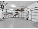 Organized garage with epoxy flooring, overhead storage, and kayak storage at 13766 Heatherfield Dr, Fishers, IN 46038