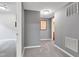 Hallway with neutral walls, plush carpet, and doorways leading to various rooms at 13766 Heatherfield Dr, Fishers, IN 46038