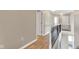 Upstairs hallway features hardwood floors, white trim, and modern lighting at 13766 Heatherfield Dr, Fishers, IN 46038