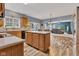 Kitchen features light wooden cabinets, a kitchen island, tile backsplash and an open layout at 13766 Heatherfield Dr, Fishers, IN 46038