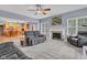 Bright living room featuring carpeted floors, neutral color scheme, ceiling fan and a fireplace with a white mantel at 13766 Heatherfield Dr, Fishers, IN 46038