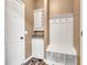 Mudroom features storage, a bench, hanging hooks, and wood-look floors at 13766 Heatherfield Dr, Fishers, IN 46038