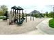 Community playground with climbing structures and slides, set against a backdrop of stylish homes at 13766 Heatherfield Dr, Fishers, IN 46038