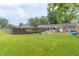 Expansive backyard with well-maintained lawn, pool, deck, sunroom, and outdoor cooking area at 1514 Bittersweet Dr, Greenfield, IN 46140