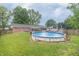 Large backyard with an above ground pool and a deck, perfect for outdoor entertaining at 1514 Bittersweet Dr, Greenfield, IN 46140