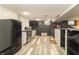 Finished basement featuring a kitchenette with stainless steel appliances and modern flooring at 1514 Bittersweet Dr, Greenfield, IN 46140