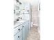Stylish bathroom featuring a vanity with blue cabinets, white countertops, and marble-like tiling at 1514 Bittersweet Dr, Greenfield, IN 46140