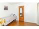 Bright bedroom featuring a single bed and wood floors, a built-in mirror on the closet door at 1514 Bittersweet Dr, Greenfield, IN 46140