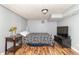 Finished basement bedroom with a modern bed, a TV with a media console, and wood floors at 1514 Bittersweet Dr, Greenfield, IN 46140