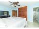 Cozy bedroom with a ceiling fan, a closet with wood doors, and an ensuite bathroom at 1514 Bittersweet Dr, Greenfield, IN 46140