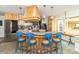 Open kitchen with stainless refrigerator, breakfast bar with blue stools, and wood cabinets at 1514 Bittersweet Dr, Greenfield, IN 46140