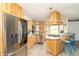 Spacious kitchen with stainless appliances, custom wooden cabinets, breakfast bar with seating, and an island cooktop at 1514 Bittersweet Dr, Greenfield, IN 46140