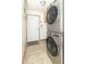 Modern laundry room featuring stackable washer and dryer units near the front door at 1514 Bittersweet Dr, Greenfield, IN 46140