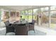 Bright sunroom with glass windows featuring outdoor dining area and views of the backyard at 1514 Bittersweet Dr, Greenfield, IN 46140