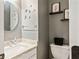 Bathroom featuring a round mirror, decorated walls, and a granite countertop at 15409 Heath Cir, Westfield, IN 46074