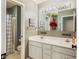 Bathroom featuring a double sink vanity with framed mirrors, and a separate shower and toilet area at 15409 Heath Cir, Westfield, IN 46074