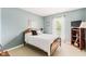 Bright bedroom with blue walls, carpet, a full bed, and a window with sheer curtains at 15409 Heath Cir, Westfield, IN 46074