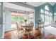 Sunlit dining area featuring hardwood floors, large windows, and a view of the outdoor deck at 15409 Heath Cir, Westfield, IN 46074