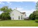 View of the home showcasing its architectural details, bright windows, and access to a spacious backyard and deck at 15409 Heath Cir, Westfield, IN 46074