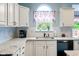Kitchen area with white cabinets, granite countertops, stainless steel appliances, and a window at 15409 Heath Cir, Westfield, IN 46074