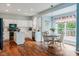 Eat-in kitchen with white cabinets, stainless steel appliances, granite countertops, and hardwood floors at 15409 Heath Cir, Westfield, IN 46074