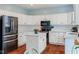 Bright kitchen featuring white cabinetry, modern appliances, and a functional center island at 15409 Heath Cir, Westfield, IN 46074