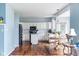 Bright kitchen with white cabinets, dark appliances, an island, and dining area with hardwood floors at 15409 Heath Cir, Westfield, IN 46074