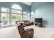 Bright living room with large windows, comfortable seating, and view to the backyard at 15409 Heath Cir, Westfield, IN 46074