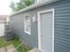 Exterior features gray siding, white trim, updated window, and access door at , Indianapolis, IN 46218