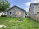 View of the backyard, showing the side of the house and the green lawn at 1844 E Minnesota St, Indianapolis, IN 46203