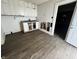 An interior view of the kitchen, highlighting cabinets, backsplash, and laminate flooring at 1844 E Minnesota St, Indianapolis, IN 46203