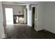 Wide view of the living room with damaged walls, featuring laminate flooring at 1844 E Minnesota St, Indianapolis, IN 46203