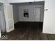 Living room featuring laminate flooring, a window, and white door at 1844 E Minnesota St, Indianapolis, IN 46203