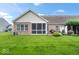 The home's backyard has an inviting screened porch and patio, perfect for entertaining and relaxing in the private outdoor space at 1905 Persimmon Grove Dr, Indianapolis, IN 46234