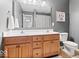 Bathroom features a double vanity, a large mirror and wood cabinets that provide plenty of storage and counter space at 1905 Persimmon Grove Dr, Indianapolis, IN 46234