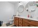 Bright bathroom features double sinks, wood cabinets, and updated fixtures at 1905 Persimmon Grove Dr, Indianapolis, IN 46234