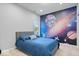 Stylish bedroom with a vibrant space mural and light-colored carpet at 1905 Persimmon Grove Dr, Indianapolis, IN 46234