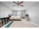Bright bedroom with a ceiling fan, large window, and neutral walls providing a serene and comfortable atmosphere at 1905 Persimmon Grove Dr, Indianapolis, IN 46234